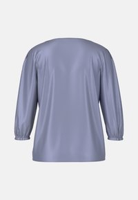Lavender satin top with three-quarter, gathered sleeves and a relaxed fit. Smooth texture and round neckline with minimal detailing.