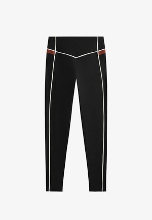 Čierne legíny s kontrastnými bielymi a hnedými akcentmi, priliehavý strih a hladká textúra. Ideálne na šport alebo bežné nosenie.