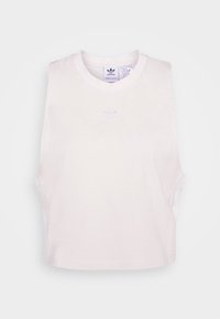 Vit ärmlös crop top i bomull. Har en rund hals och en subtilt broderad logotyp i mitten. Mjuk textur, minimalistisk design.