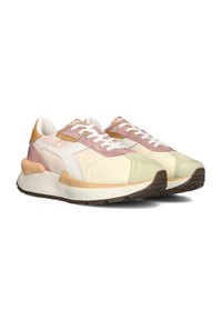 Sport sneakers featuring a creamy upper with light pink and tan accents, white laces, and a textured green toe. Thick white midsole and brown outsole.