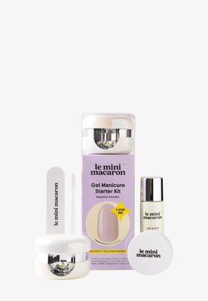 Lámpara compacta de LED para uñas, botella de esmalte en gel, lima de uñas y embalaje para el kit de inicio de manicura con gel le mini macaron en color lila pálido y blanco.