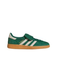 Green suede Adidas Spezial sneaker with white stripes, velcro strap, and brown textured sole, shown in side profile on white background.