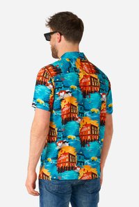 Camicia a maniche corte con bottoni, caratterizzata da un motivo vivace di edifici e personaggi in tonalità di blu, arancione e giallo su uno sfondo chiaro.