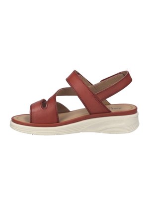 Sandale en cuir marron à bout ouvert avec deux brides, dont une autour de la cheville, semelle intérieure beige coussinée et épaisse semelle blanche.