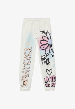Witte sweatpants met een elastische tailleband, met kleurrijke grafische prints: bloemen, tekst "WHATEVER," en abstracte spetters in roze en blauw.