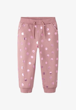 Ružové teplákové nohavice pre batoľatá s kovovými ružovými bodkami, elastickým pásom, sťahovacou šnúrkou, bočnými vreckami a rebrovanými manžetami.