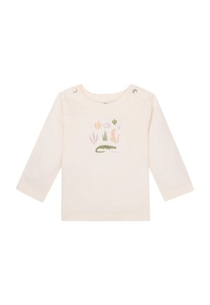 Light cream long-sleeve shirt made of cotton, featuring an illustrated design of a crocodile and plants, with snap buttons on the shoulder.