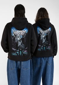 Black hoodie featuring a graphic of a knight on horseback amidst trees. The design includes blue and purple accents, displayed on the back.