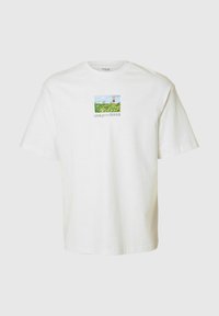 Biała bawełniana koszulka z małym prostokątnym nadrukiem przedstawiającym zielony krajobraz i niebieskie niebo, z napisem na dole, luźny krój, krótkie rękawy.