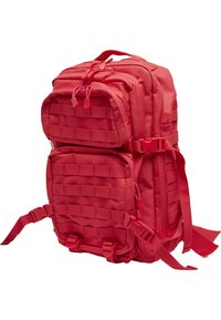 Punainen taktinen reppu, valmistettu kestävästä kankaasta. Sisältää useita vetoketjullisia taskuja, säädettävät hihnat ja kiinnitysnauhat.