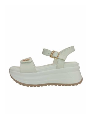 Sandalo platform bianco con suola spessa, cinturino alla caviglia regolabile con fibbia dorata e cinturino frontale con dettaglio del logo dorato.