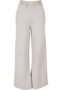 Lichtgrijze wijde broek van zacht materiaal met een elastische tailleband en zijslitsen, met een gladde textuur en een minimalistisch ontwerp.