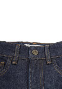 Dark denim jeans with orange stitching, featuring a metal button with "BXR" logo, five-pocket design, and standard waistband.