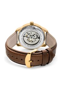 Round automatic watch with a transparent back; gold-tone stainless steel case, brown leather strap, and a polished buckle with holes.