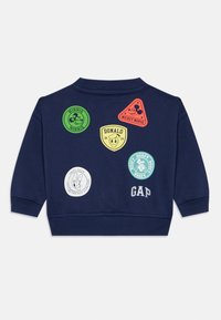 Marineblaue Kinder-Sweatshirt mit bunten Disney-Charakter-Patches: Minnie, Mickey, Donald, Daisy, Goofy und dem GAP-Logo auf dem Rücken.