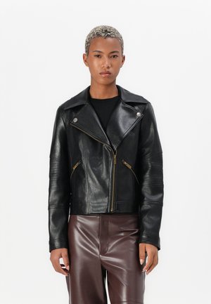 Black leather motorcycle jacket with a notched collar, zippered front, and two zippered side pockets. Features textured sleeves and gold accents.