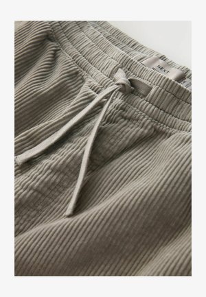 Light gray ribbed lounge pants with an elastic waistband and adjustable drawstring. Label shows brand name "NEXT." Soft texture.