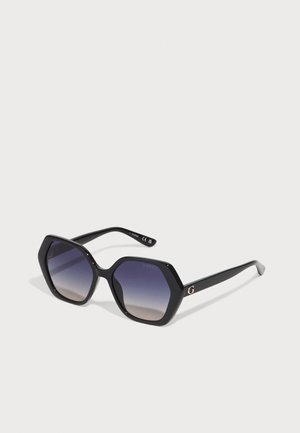 Ochelari de soare hexagonali negri cu lentile gradient. Prezintă o finisare lucioasă și un logo subtil 'G' în auriu roz pe tâmplă.