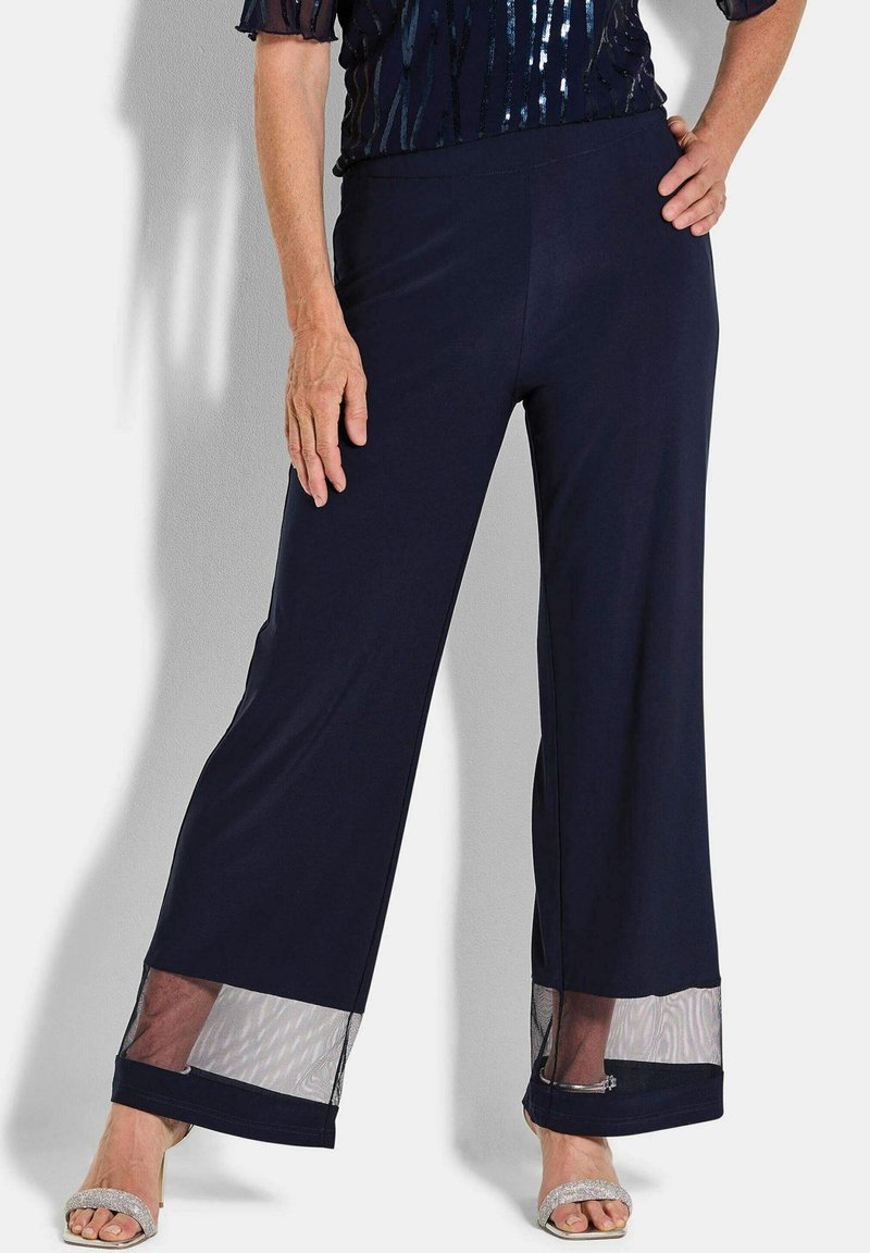 Marine elastische taillebroek met brede pijpen, voorzien van doorschijnende gaasaccenten aan de zoom en een gladde stoftextuur. Geschikt voor verschillende gelegenheden.