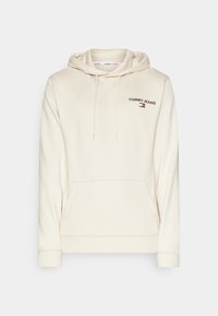 Felpa crema in misto cotone. Presenta una tasca a marsupio, polsini e orlo a coste. Logo "TOMMY JEANS" in nero sul lato sinistro del petto.
