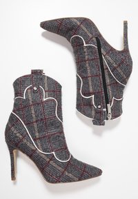 Gray plaid high-heel ankle boots with pointed toe, white scalloped accents, and side zipper detail. Made from textured fabric.
