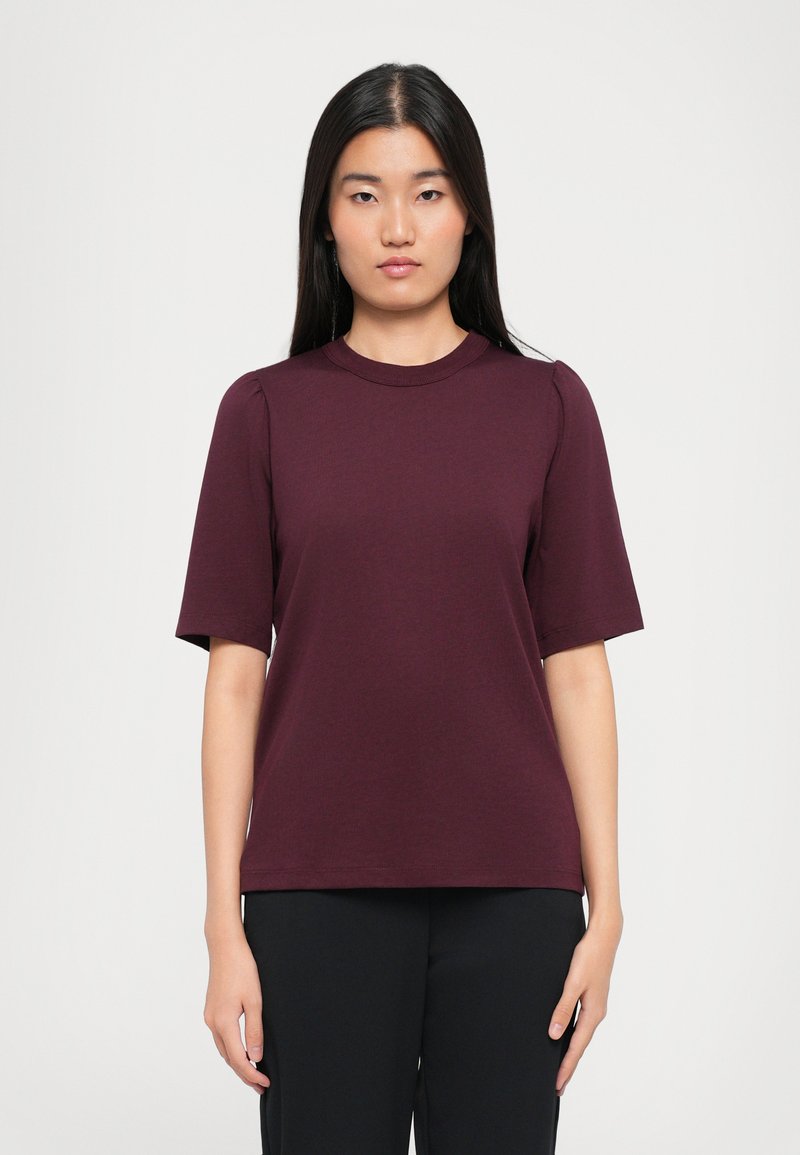 Burgundy short-sleeve t-shirt made of soft cotton-blend fabric, featuring a round neckline and subtle shoulder detailing for added structure.