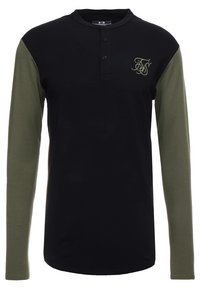 Long-sleeve shirt with a black body and olive green sleeves, featuring a henley neckline, three buttons, and a decorative logo on the chest.