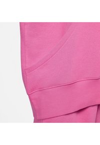 Fleece hoodie in vibrant pink, featuring a kangaroo pocket, ribbed cuffs, and a smooth texture. Displays stitched seams and a relaxed fit.