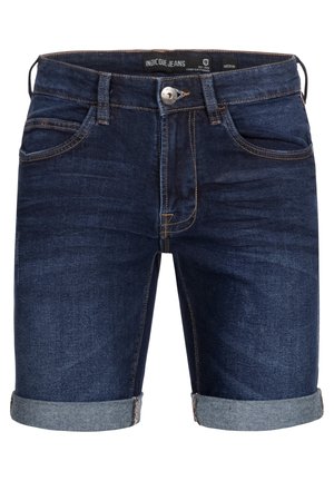 Sötétkék farmer sort, feltekert szegéllyel, ötpocket kialakítással és kontrasztos varrással. Gombbal záródik és övhurkokkal rendelkezik.