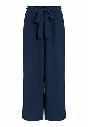 Temno modre široke hlače z visokim pasom v stilu papirnatega vrečka in usklajenim trakom iz tkanine, zavezanim v lok spredaj.