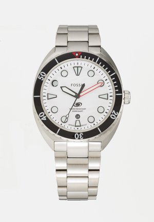 Montre en acier inoxydable avec un cadran blanc, une lunette noire et une étanchéité jusqu'à 200 m. Présente des index horaires audacieux et une aiguille des secondes rouge.