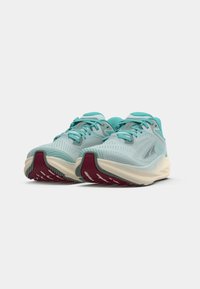 Light blue running shoes with a breathable mesh upper, white midsole, and a textured dark red outsole. Features gray accents and laces.