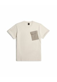 T-shirt in cotone beige chiaro con taschino in un beige più scuro, design a girocollo, maniche corte, texture liscia e stile minimalista.