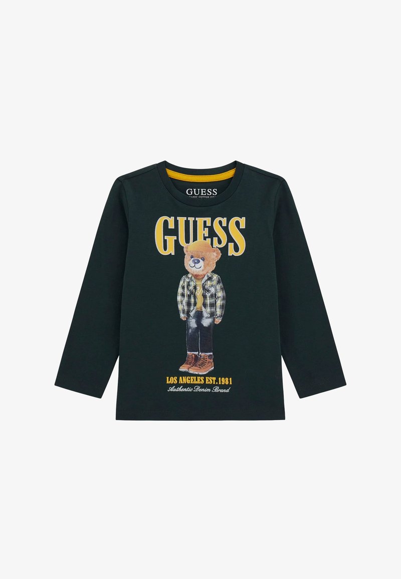 Hosszú ujjú fekete pamut ing, amelyen plüss mackó grafika látható kockás öltözetben, sárga kiegészítőkkel, valamint a "GUESS" és a "LOS ANGELES EST. 1981." feliratokkal.