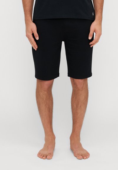 Sorte bomuldsshorts med slim fit, der når til midten af låret. Har en enkel kant uden synlige mønstre eller ekstra hardware.