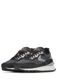 Sneakers featuring a mix of gray and black suede and textile, textured upper, cushioned sole, and laces. Logo on tongue. Notable layered design.