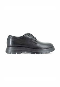 Scarpa da uomo in pelle nera con punta tonda, cuciture minime e suola in gomma texturizzata per la trazione. Design classico con lacci.