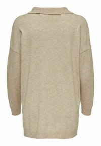 Beige oversized svetr s límcem, volný střih a texturovaný úplet. Hladké manžety a lem zvýrazňují uvolněný design.