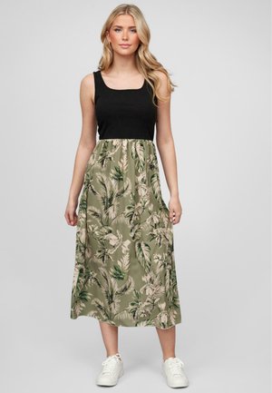 Débardeur noir à encolure carrée, se transformant en jupe à motifs floraux verts. Présente un design mi-long et un tissu léger.