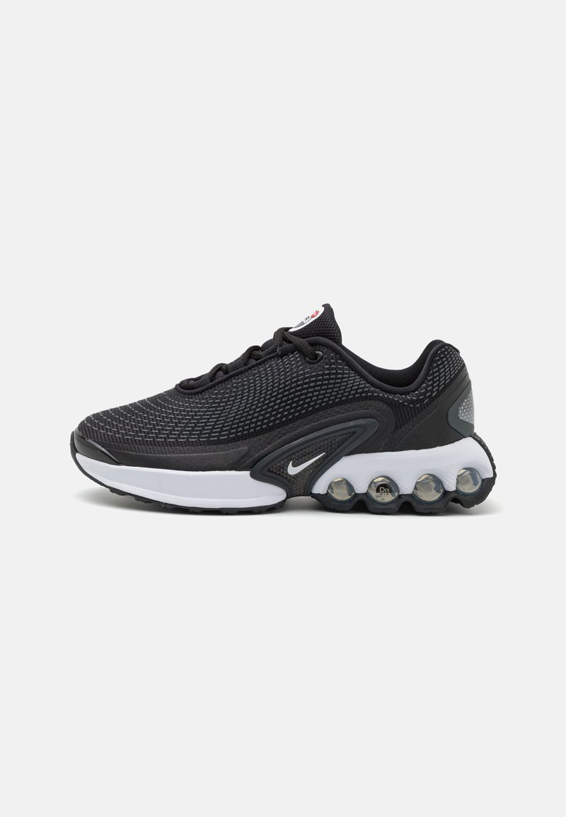 Black athletic shoe with mesh upper, white midsole, and a unique heel featuring visible air cushioning pods. Notable Nike logo on the side.