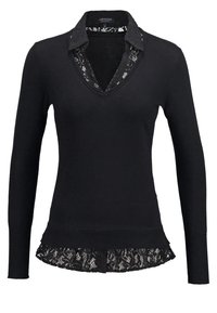 Pull noir à manches longues avec une bordure en dentelle au bas et au col. Design en V avec une couche de dentelle en dessous. Fabriqué en un matériau tricoté doux.