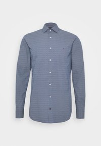 Miesten napillinen paita tummansinisellä pohjalla ja graafisella kuviolla, jossa on pitkät hihat ja kaulus, valmistettu kevyestä kankaasta. Korostettuna logolla.