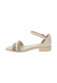 Sandal beige con un motivo testurizzato e una fascia stretta alla caviglia. Presenta una punta aperta e un tacco basso a blocco per un supporto stabile.
