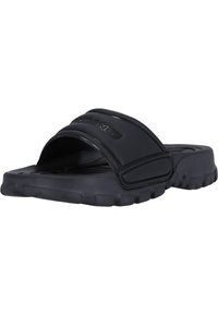 Black slide sandal made of rubber with a textured sole, curved footbed, and wide top strap featuring embossed logo detail.
