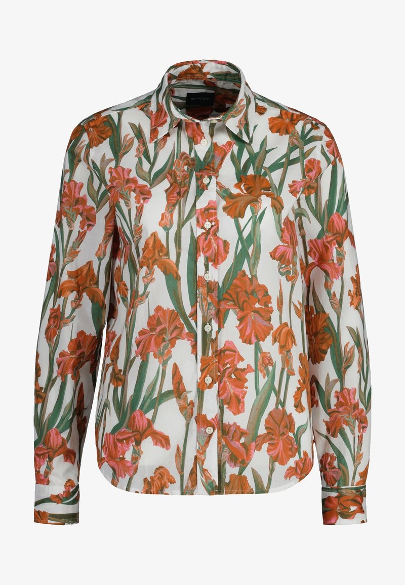 Chemise blanche à manches longues avec un motif de fleurs d'iris orange et rose, accompagnées de tiges et feuilles vertes.