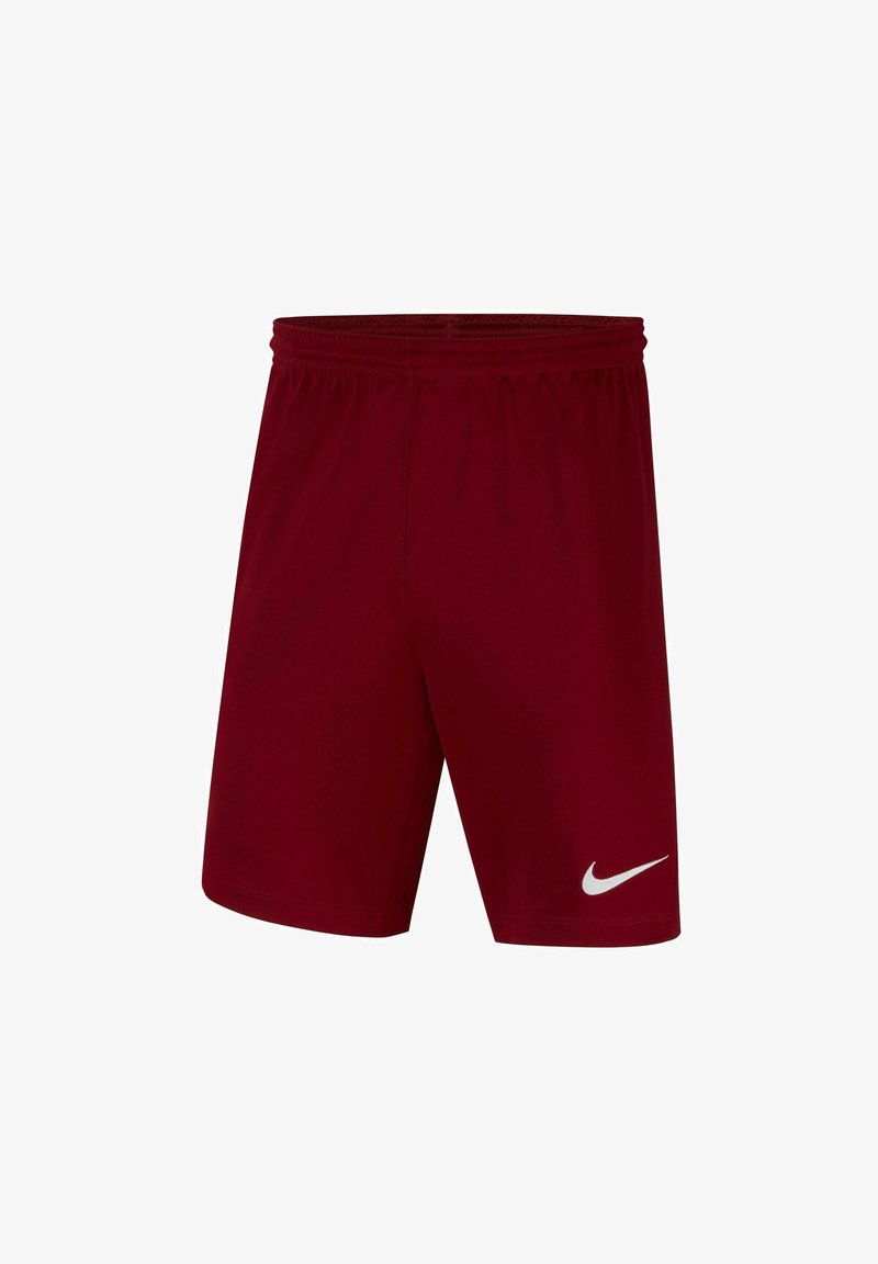 Shorts de sport rouges en tissu léger, dotés d'une taille élastique et d'un logo Nike blanc sur le bas de la jambe gauche.