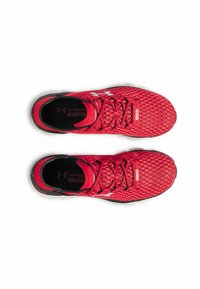 Red athletic shoes feature a textured mesh upper, flat laces, branded accents, and a black rubber outsole for traction and support.