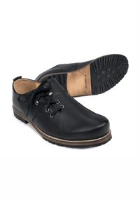 Schwarze Lederschuhe mit abgerundeter Zehenpartie, Schnürdesign und Gummisohle mit Profilmustern. Braune Akzente um die Zwischensohle.