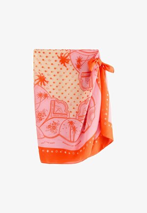Oranje en roze stoffen met palmboom-, bloemen-, polkadot- en hartpatronen en een knoop vastgebonden in een hoek.