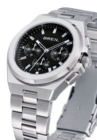 Montre en acier inoxydable argenté avec un cadran noir. Elle dispose de trois sous-cadrans, d'index horaires argentés et d'un bracelet à maillons poli.